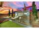 Beautiful water feature with landscape lighting enhances the backyard ambiance, perfect for evening gatherings at 12816 Alcores St, Las Vegas, NV 89141