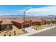 Exterior view of single-Gathering homes with desert landscaping and mountain views in the background at 1398 Pin Cushion Rdg, Mesquite, NV 89034