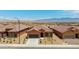 Single-story home showcasing desert landscaping, a driveway, and scenic mountain views in distance at 1398 Pin Cushion Rdg, Mesquite, NV 89034