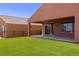 Beautiful backyard features lush artificial turf and a covered patio, perfect for outdoor entertaining at 1398 Pin Cushion Rdg, Mesquite, NV 89034