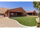 Beautiful backyard features lush artificial turf, gravel beds, and covered patio at 1398 Pin Cushion Rdg, Mesquite, NV 89034