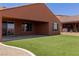 Beautiful backyard with lush artificial grass, covered patio, and views at 1398 Pin Cushion Rdg, Mesquite, NV 89034