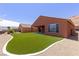 Spacious backyard features lush artificial turf, gravel beds, and covered patio at 1398 Pin Cushion Rdg, Mesquite, NV 89034