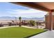 Backyard featuring a manicured lawn and panoramic mountain views at 1398 Pin Cushion Rdg, Mesquite, NV 89034