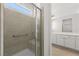 Modern bathroom featuring a tiled walk-in shower with a bench and a large vanity at 1398 Pin Cushion Rdg, Mesquite, NV 89034