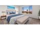 Beautiful staged bedroom with a large window, bed, bench, and lamps at 1398 Pin Cushion Rdg, Mesquite, NV 89034