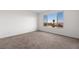 Bright bedroom with a large window showcasing scenic views of the surrounding landscape at 1398 Pin Cushion Rdg, Mesquite, NV 89034