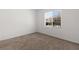 Neutral bedroom features a window, carpet floors, and neutral colored walls at 1398 Pin Cushion Rdg, Mesquite, NV 89034