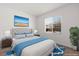 Cozy staged bedroom with a view, bed, and warm lighting fixtures at 1398 Pin Cushion Rdg, Mesquite, NV 89034