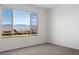 Light-filled bedroom with a large window providing views of mountains and neighborhood at 1398 Pin Cushion Rdg, Mesquite, NV 89034