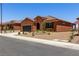 Single-story house with neutral desert landscape, a driveway, and tile roof at 1398 Pin Cushion Rdg, Mesquite, NV 89034