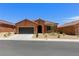 Single-story house with neutral desert landscape, a driveway, and tile roof at 1398 Pin Cushion Rdg, Mesquite, NV 89034