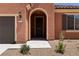 Charming single-story home featuring an arched entryway, desert landscaping, and a two-car garage at 1398 Pin Cushion Rdg, Mesquite, NV 89034