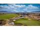 Picturesque view of the golf course with a waterfall, pond, and lush green fairways and mountain view at 1398 Pin Cushion Rdg, Mesquite, NV 89034