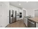 Modern kitchen featuring stainless steel appliances, granite countertops, and white cabinetry at 1398 Pin Cushion Rdg, Mesquite, NV 89034