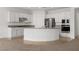 Bright kitchen with white cabinetry, granite countertops, and a large central island for food prep at 1398 Pin Cushion Rdg, Mesquite, NV 89034