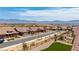Scenic street view of homes with desert landscaping, clear blue sky and mountain views at 1398 Pin Cushion Rdg, Mesquite, NV 89034