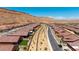 Wide street view showcases a neighborhood of single-story homes with desert landscaping and mountain views at 1398 Pin Cushion Rdg, Mesquite, NV 89034