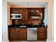 Kitchenette area with dark wood cabinetry, stainless steel appliances, sink, and a coffee maker at 145 E Harmon Ave # 2409, Las Vegas, NV 89109