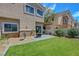 The home's backyard features artificial grass, a water feature, and a small patio area at 1574 Ward Frontier Ln, Henderson, NV 89002