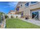 A cozy backyard featuring artificial grass, a small patio, and lush landscaping at 1574 Ward Frontier Ln, Henderson, NV 89002