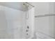 Clean white bathroom with tiled walls, a shower and bath combination, and towel bar at 1574 Ward Frontier Ln, Henderson, NV 89002