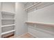 Walk-in closet with multiple shelves and wooden clothes rods at 1574 Ward Frontier Ln, Henderson, NV 89002