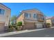 Inviting two-story home featuring a two-car garage, desert landscaping and neutral color palette at 1574 Ward Frontier Ln, Henderson, NV 89002