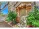 A charming front entrance with a decorative front door and mature landscaping at 1574 Ward Frontier Ln, Henderson, NV 89002
