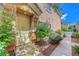 A home's front entrance with a storm door, small landscaped area, and a sidewalk at 1574 Ward Frontier Ln, Henderson, NV 89002