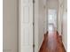Hallway with wood floors leading to bedrooms and bathrooms at 1574 Ward Frontier Ln, Henderson, NV 89002