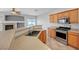 Kitchen featuring breakfast bar, stainless steel appliances, and wood cabinets at 1574 Ward Frontier Ln, Henderson, NV 89002