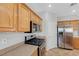 Kitchen with wood cabinets and stainless steel oven and microwave at 1574 Ward Frontier Ln, Henderson, NV 89002