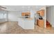 Open concept kitchen with breakfast bar, wood cabinets, and stainless appliances at 1574 Ward Frontier Ln, Henderson, NV 89002