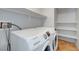 Bright laundry room area with shelving above the Samsung washer and dryer at 1574 Ward Frontier Ln, Henderson, NV 89002