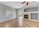 Bright living room features tile floors, fireplace, and sliding glass door access to backyard at 1574 Ward Frontier Ln, Henderson, NV 89002