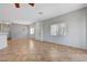 Expansive living space with tile flooring, large windows, and view of the dining area at 1574 Ward Frontier Ln, Henderson, NV 89002