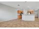 Open-concept living area with tile floors, view of the kitchen with stainless steel appliances at 1574 Ward Frontier Ln, Henderson, NV 89002