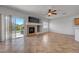 Bright living room boasts tile floors, fireplace, and sliding glass door access to backyard at 1574 Ward Frontier Ln, Henderson, NV 89002