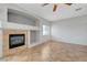 Spacious living room featuring a corner fireplace, tile flooring, and ample natural light at 1574 Ward Frontier Ln, Henderson, NV 89002