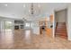 Open floor plan living space with fireplace, breakfast bar, and stairway at 1574 Ward Frontier Ln, Henderson, NV 89002