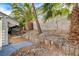 Backyard boasts a beautiful lawn and palm trees, creating a lush and inviting outdoor space at 1600 Becke Cir, Las Vegas, NV 89104