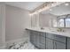 Elegant bathroom vanity with double sinks, marble countertop, and contemporary lighting at 1600 Becke Cir, Las Vegas, NV 89104