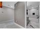 Hallway view to bathroom with marble tile, modern vanity, and shower/tub combo at 1600 Becke Cir, Las Vegas, NV 89104