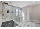 Luxurious bathroom featuring a soaking tub, walk-in shower with marble tile, and modern fixtures at 1600 Becke Cir, Las Vegas, NV 89104