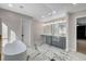 Spa-like bathroom with soaking tub, double vanity, and walk-in shower with glass enclosure at 1600 Becke Cir, Las Vegas, NV 89104