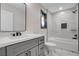 Elegant bathroom with a marble countertop vanity, black fixtures, and a tiled shower-tub combo at 1600 Becke Cir, Las Vegas, NV 89104