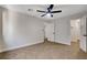 Bedroom features neutral tones, two doors, a ceiling fan, and a window at 1600 Becke Cir, Las Vegas, NV 89104
