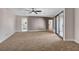Spacious carpeted bedroom features a modern ceiling fan and large sliding glass doors at 1600 Becke Cir, Las Vegas, NV 89104