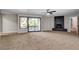 Spacious carpeted bedroom features a modern ceiling fan, fireplace, and balcony access at 1600 Becke Cir, Las Vegas, NV 89104